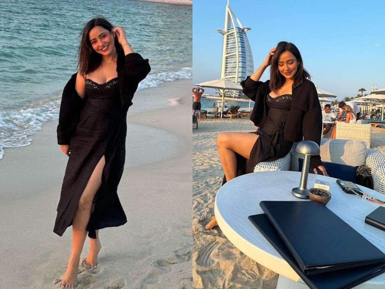 Stuns in a black slit dress